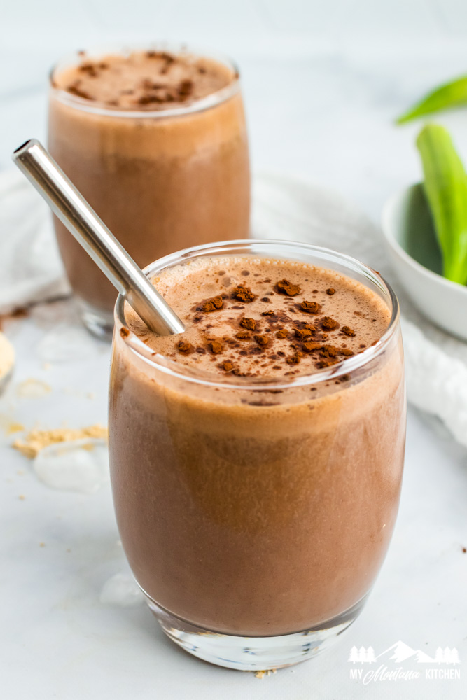 chocolate peanut butter milkshake in glass with metal straw