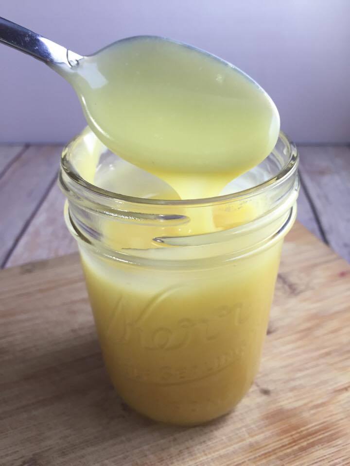 homemade condensed milk with spoon and glass jar