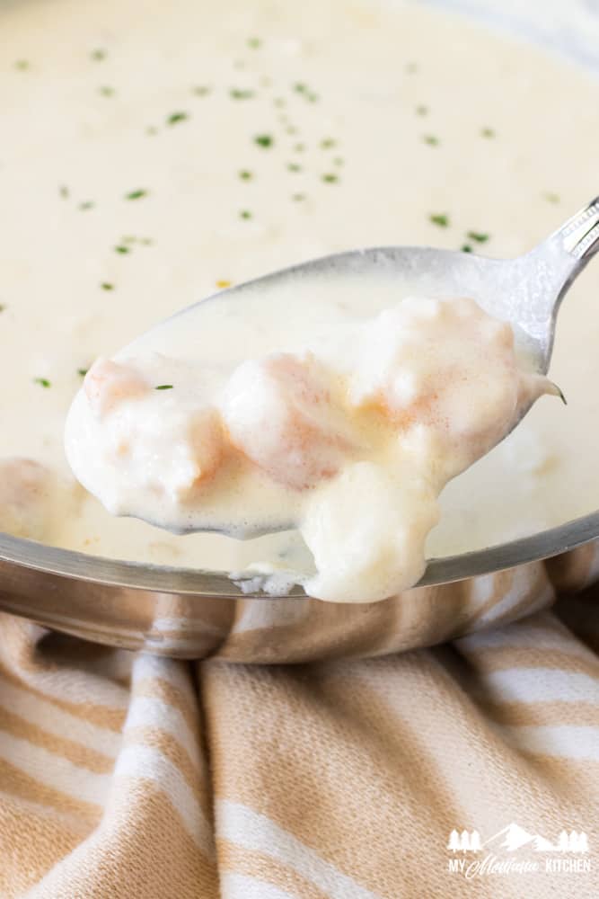 creamy shrimp alfredo in spoon with saucepan