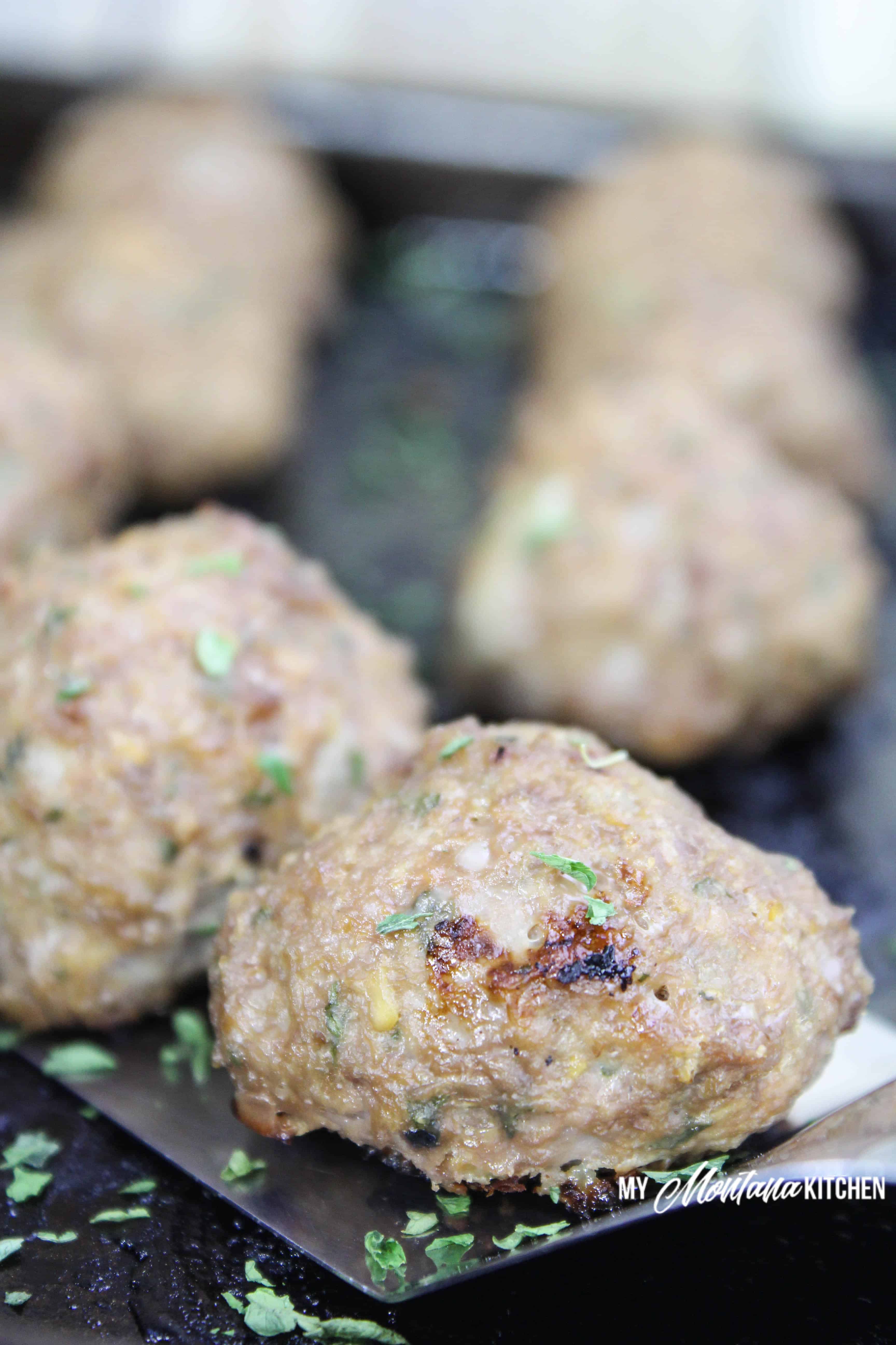 low carb meatballs on a spatula on baking sheet