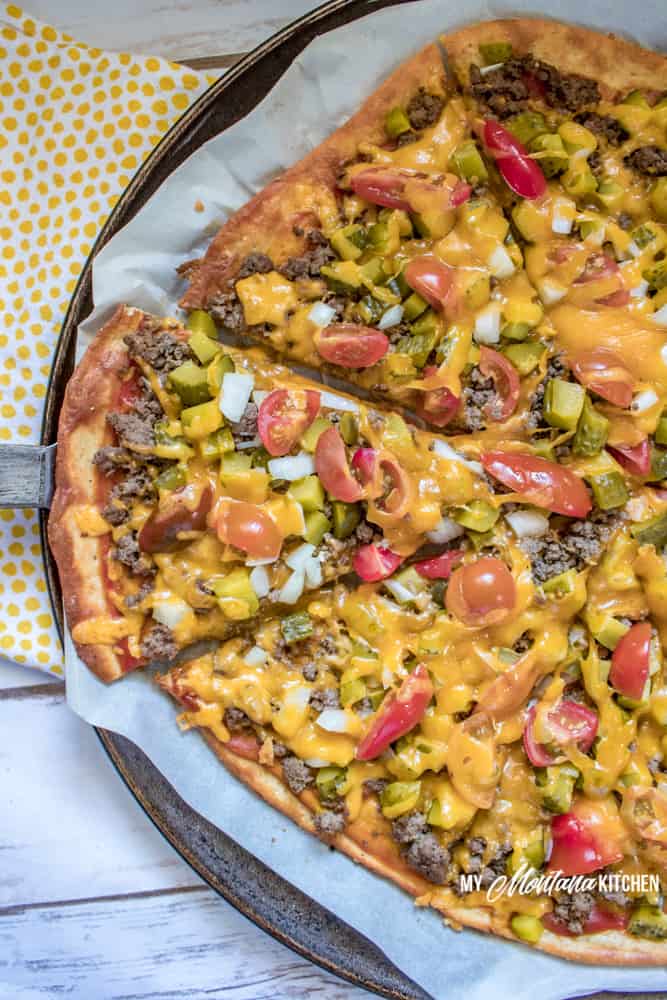 Combine the best of both cheeseburgers and pizza and you have a delicious and easy dinner idea - Cheeseburger Pizza! Using a low carb crust and lots of toppings, this keto pizza is perfect for a family dinner! #trimhealthymama #thm #lowcarb #keto #cheeseburger #pizza #groundbeef #easyrecipe #glutenfree
