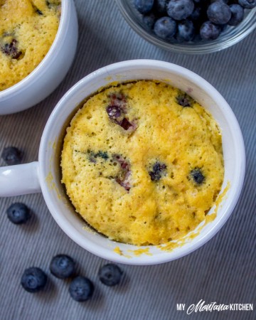 Sweet, tender, and bursting with blueberries, this Low Carb Blueberry Muffin in a Mug can be in your hands in less than 5 minutes! (And, you don’t even have to turn on your oven!) You would never know this blueberry muffin is sugar free! #trimhealthymama #thm #lowcarb #glutenfree #sugarfree #blueberrymuffin #blueberries #muffininamug #mim #mymontanakitchen #lowcarbmuffin