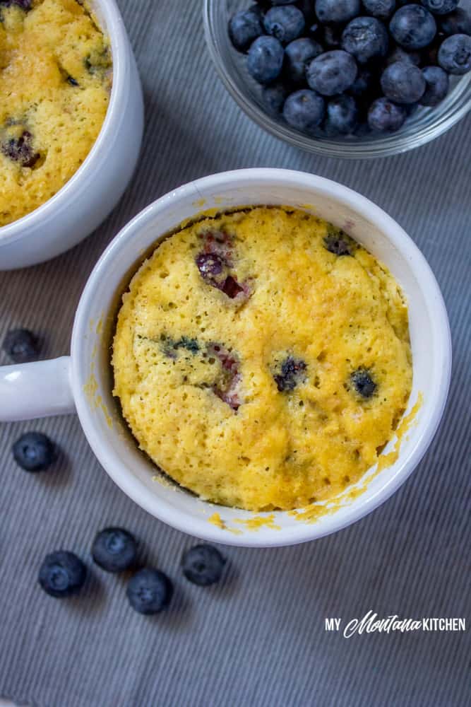 Sweet, tender, and bursting with blueberries, this Low Carb Blueberry Muffin in a Mug can be in your hands in less than 5 minutes! (And, you don’t even have to turn on your oven!) You would never know this blueberry muffin is sugar free! #trimhealthymama #thm #lowcarb #glutenfree #sugarfree #blueberrymuffin #blueberries #muffininamug #mim #mymontanakitchen #lowcarbmuffin