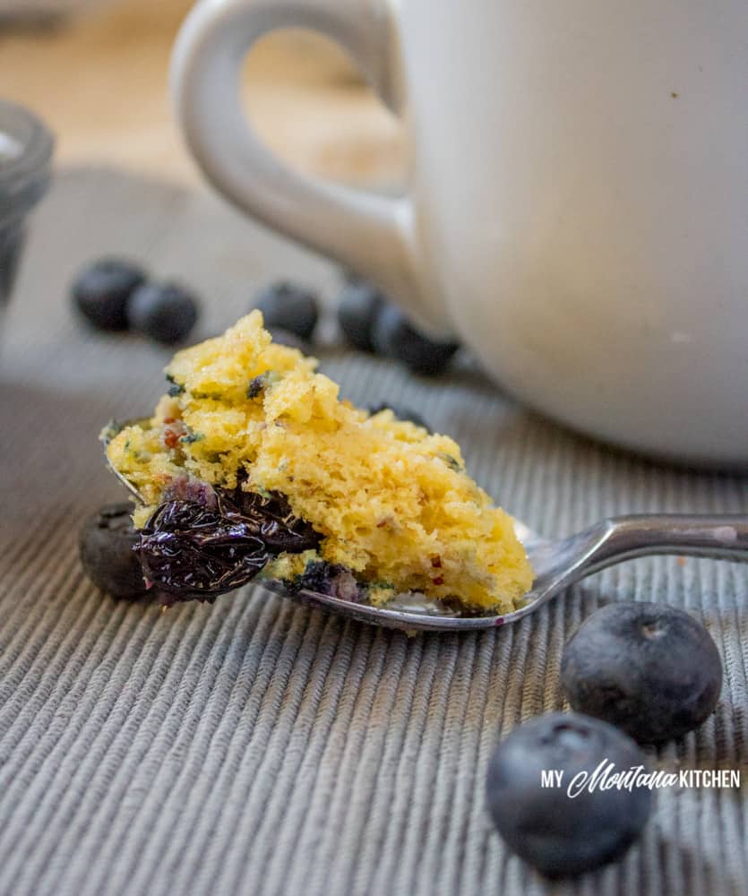 Sweet, tender, and bursting with blueberries, this Low Carb Blueberry Muffin in a Mug can be in your hands in less than 5 minutes! (And, you don’t even have to turn on your oven!) Not only is the Blueberry Muffin in a Mug low carb and keto friendly, it is also dairy free, gluten free, full of fiber, and a Trim Healthy Mama S Recipe. #trimhealthymama #thm #lowcarb #glutenfree #sugarfree #blueberrymuffin #blueberries #muffininamug #mim #mymontanakitchen #lowcarbmuffin