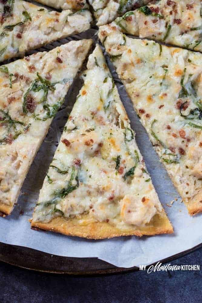 This low carb Chicken Alfredo Pizza recipe is a satisfying (and delicious!) gluten free pizza that you're going to want to make again and again. Just because you're eating low carb, doesn't mean you have to sacrifice your favorite foods. This low carb Chicken Alfredo Pizza recipe is proof of that! With the perfect low carb crust and creamy parmesan garlic sauce, this Chicken Alfredo Pizza makes a great low carb family dinner! #pizza #lowcarbpizza #ketopizza #alfredo #alfredopizza #lowcarb #keto #glutenfree #trimhealthymama #thms #thmpizzarecipe #familydinnerrecipe