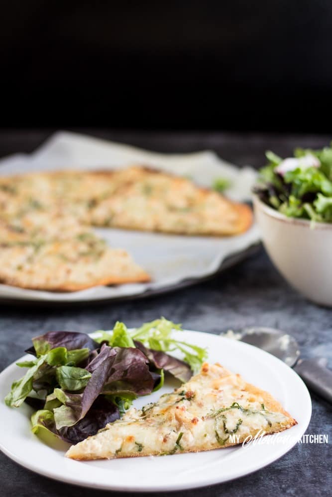 This low carb Chicken Alfredo Pizza recipe is a satisfying (and delicious!) gluten free pizza that you're going to want to make again and again. Just because you're eating low carb, doesn't mean you have to sacrifice your favorite foods. This low carb Chicken Alfredo Pizza recipe is proof of that! With the perfect low carb crust and creamy parmesan garlic sauce, this Chicken Alfredo Pizza makes a great low carb family dinner! #pizza #lowcarbpizza #ketopizza #alfredo #alfredopizza #lowcarb #keto #glutenfree #trimhealthymama #thms #thmpizzarecipe #familydinnerrecipe