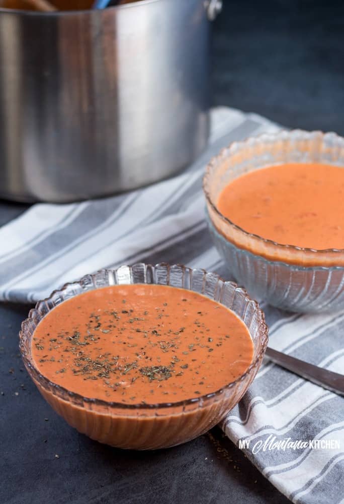 This creamy low carb tomato soup makes an easy dinner idea for families, or makes a great easy lunch! Leftovers can easily be reheated for later, making this a versatile healthy meal idea! #lowcarb #thm #trimhealthymama #tomato #tomatosoup #glutenfree #lowcarbsoup #healthymealidea #easylowcarbrecipe #trimhealthymamasoup