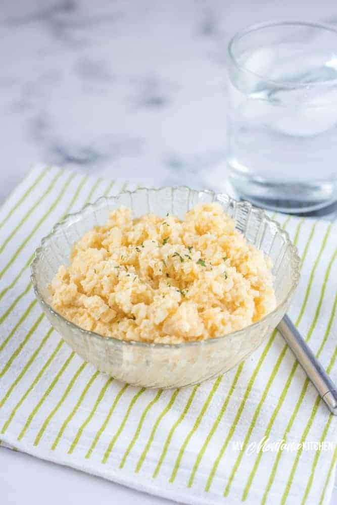 Easy cheesy cauliflower rice is the perfect keto side dish, but it can also make for a fabulous one-bowl low carb dinner. This cauliflower rice recipe is creamy, rich, low carb comfort food at its finest! #cauliflowerrice #cheesycauliflower