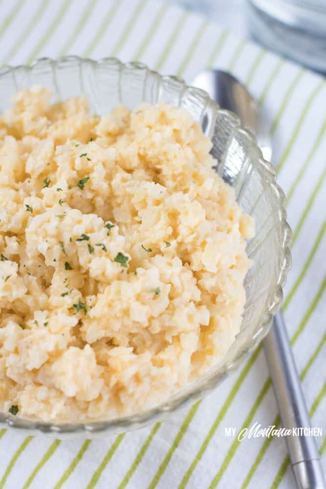 Easy cheesy cauliflower rice is the perfect keto side dish, but it can also make for a fabulous one-bowl low carb dinner. This cauliflower rice recipe is creamy, rich, low carb comfort food at its finest! #caulirice #cheesycauliflower