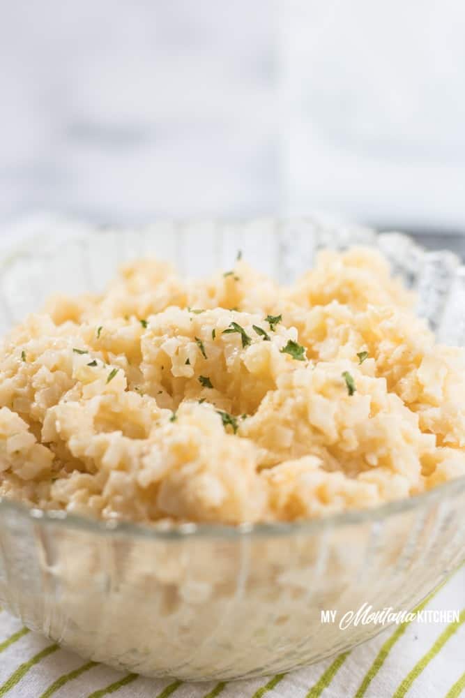 Easy cheesy cauliflower rice is the perfect keto side dish, but it can also make for a fabulous one-bowl low carb dinner. This cauliflower rice recipe is creamy, rich, low carb comfort food at its finest! #cauliflowerrice #cheesycauliflower