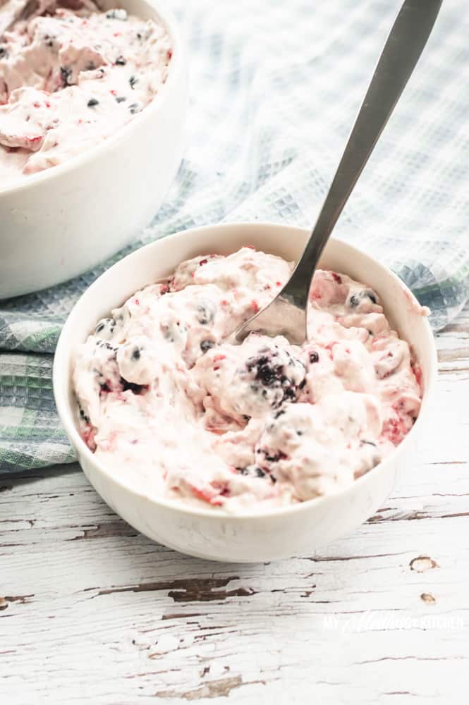This easy Cheesecake Berry Salad recipe works for keto, THM, and it is also sugar free. Fresh berries wrapped in a cheesecake “fluff” make an excellent dessert or side! #cheesecakeberrysalad #thm #keto