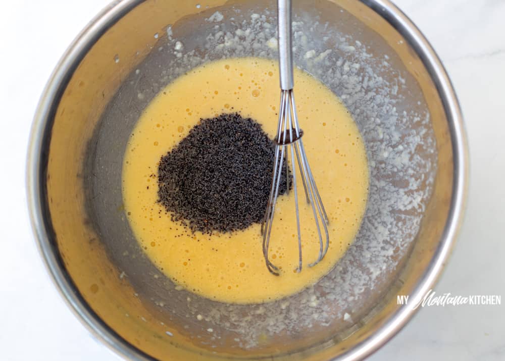 mixing in the poppyseed into wet muffin mixture 