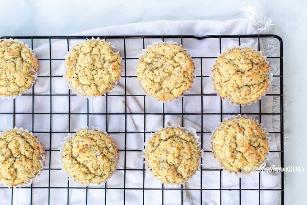 keto lemon poppyseed muffins sitting on a wire rack cooling 