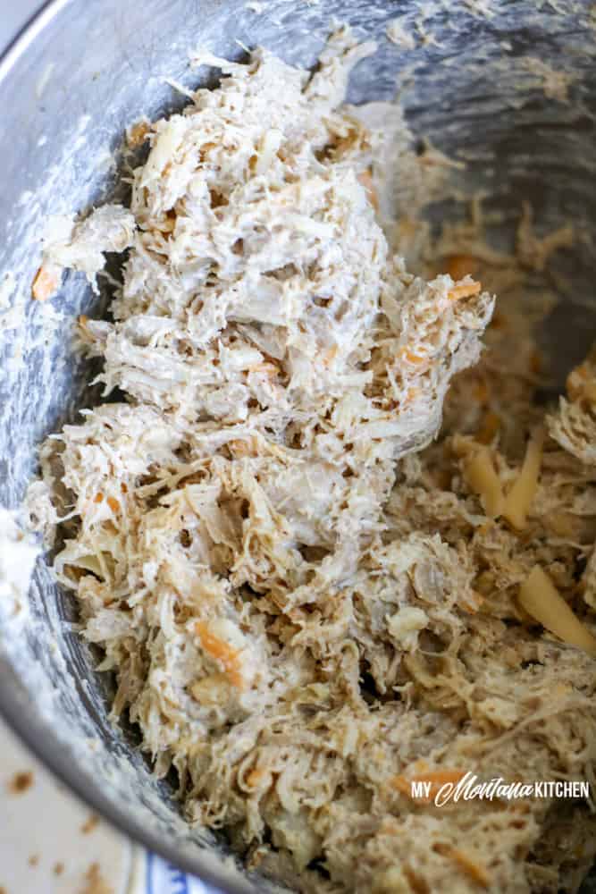 shredded chicken and cream cheese in mixing bowl