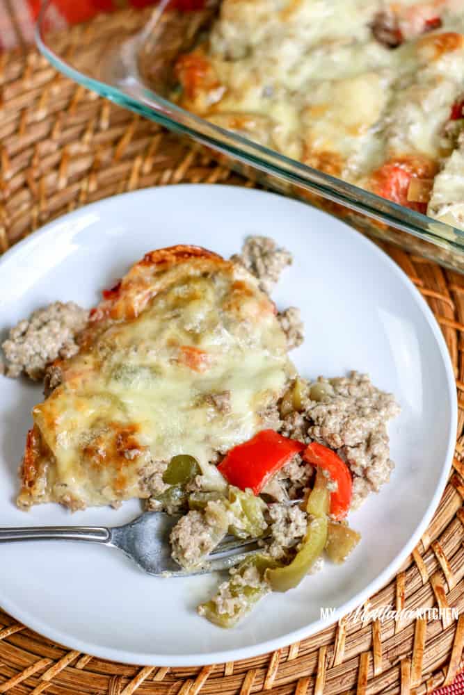 low carb philly cheesesteak casserole on white plate with fork