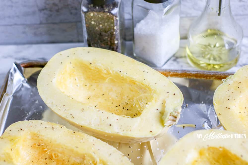 raw spaghetti squash on baking tray