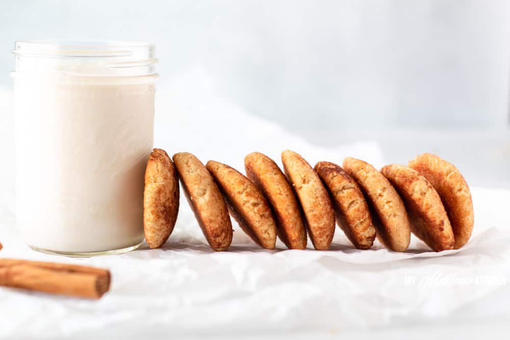 row of snickerdoodles leaning against glass of milk