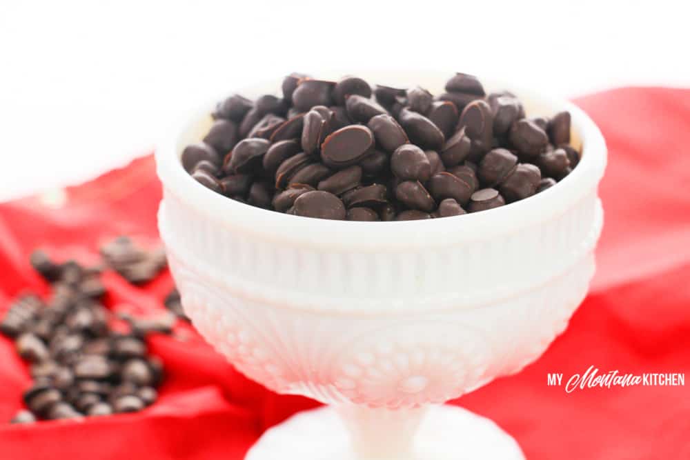 chocolate covered espresso beans in white dish on red cloth