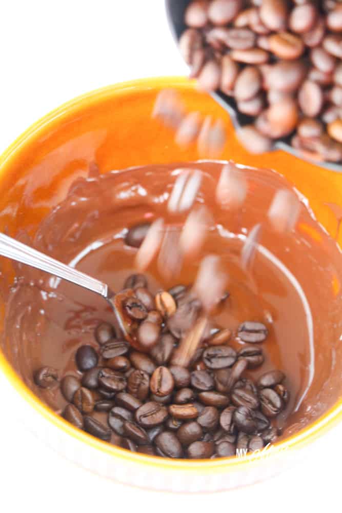 adding coffee beans to melted chocolate
