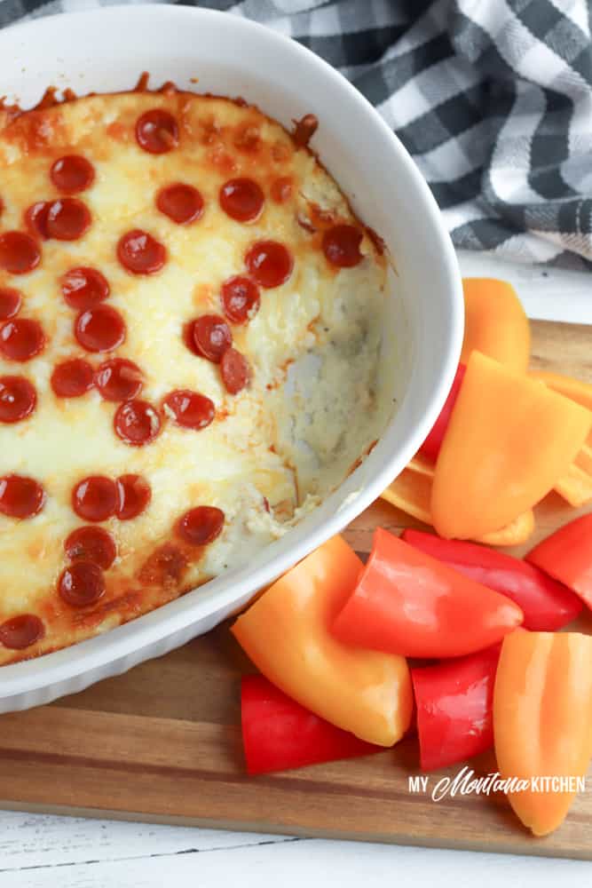 Baked low-carb cheesy pepperoni dip with mini bell peppers for serving