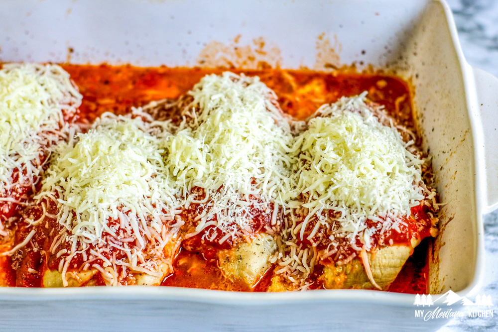 baked chicken breast with red sauce and cheese in baking pan