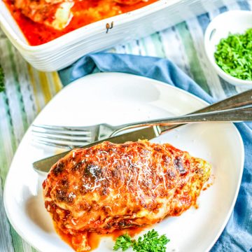 baked lasagna chicken on white plate with fork