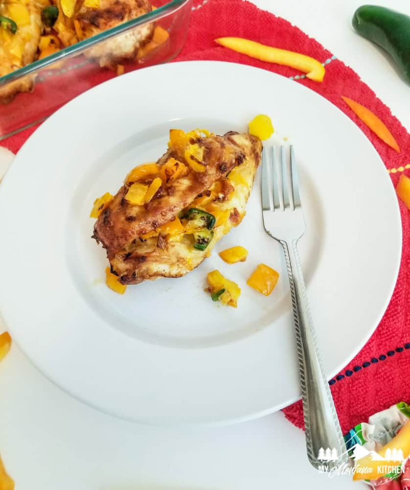 fajita stuffed chicken on white plate with fork