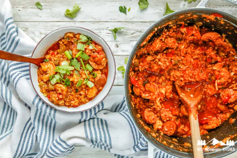 bowl of jambalaya beside pot