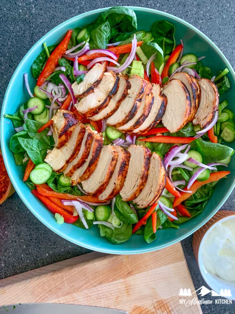 Top your salad with sliced chicken breasts