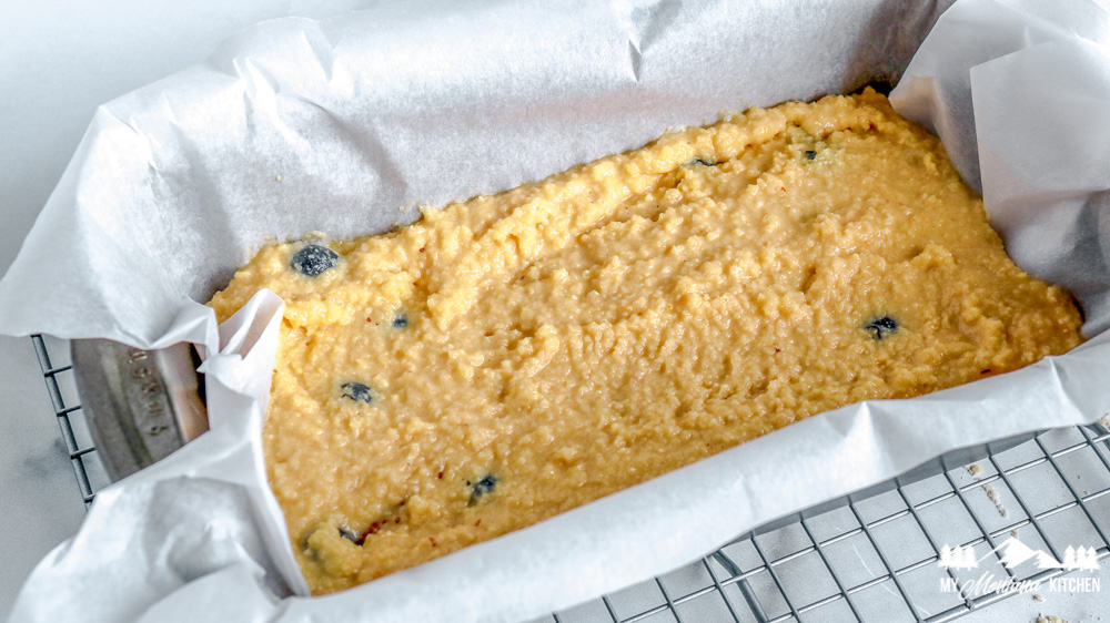 Line a loaf pan with parchment paper and add batter