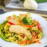 easy chicken lo mein in white dish with chopsticks