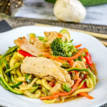 easy chicken lo mein in white dish with chopsticks