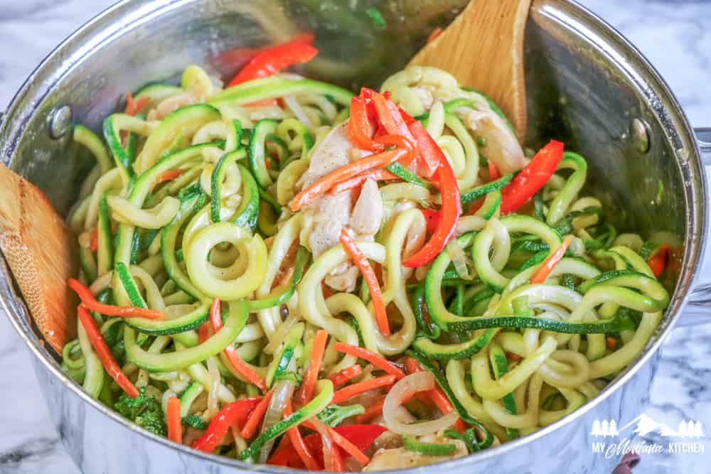 zucchini noodles with chicken and red peppers and onions