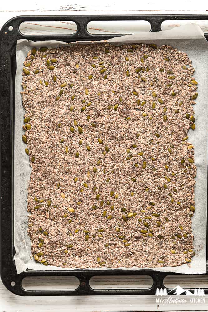 seed crackers on baking sheet lined with parchment paper