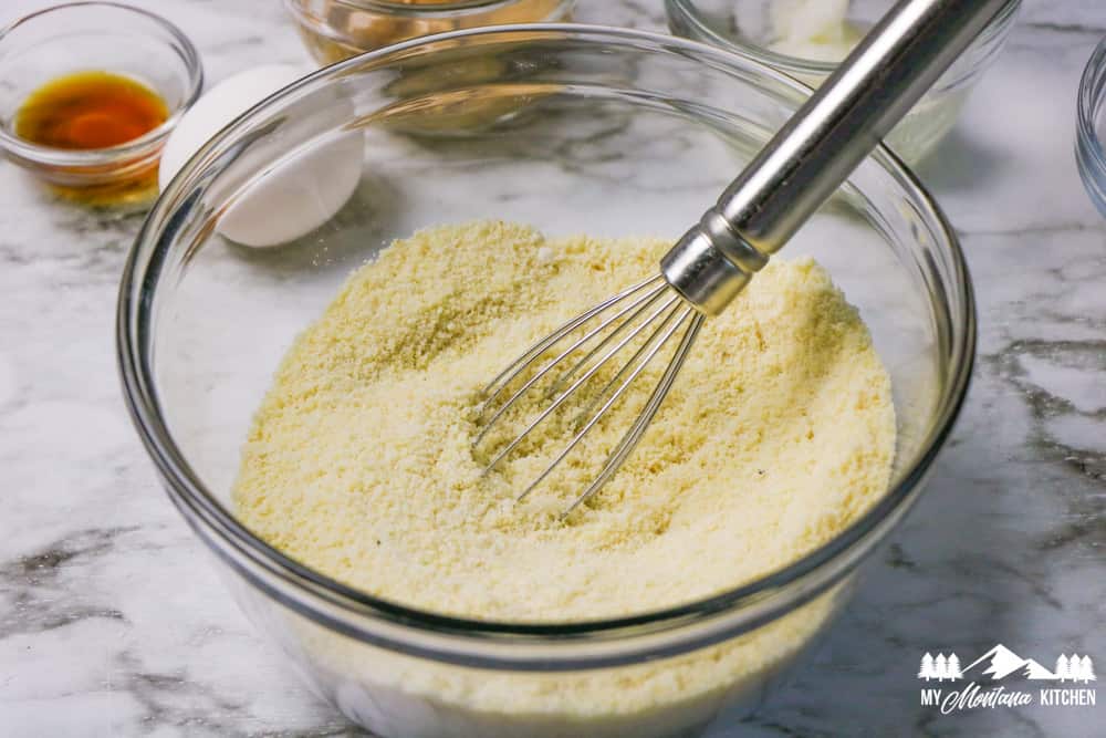 mixed dry ingredients for scones in a glass bowl with a whisk