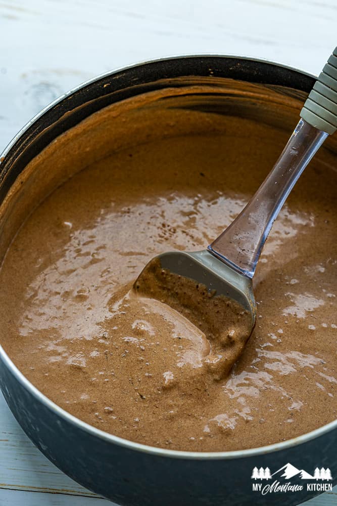 chocolate panna cotta in saucepan with spatula