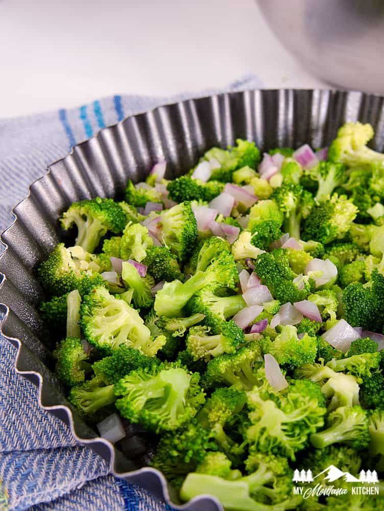 broccoli and purple onion in tart pan