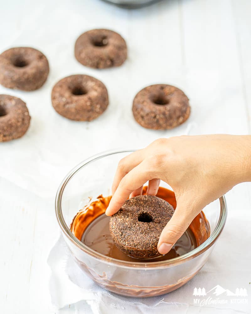 dipping chocolate donuts in chocolate glaze