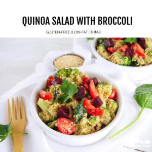 quinoa salad in white bowl with wooden fork