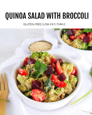 quinoa salad in white bowl with wooden fork