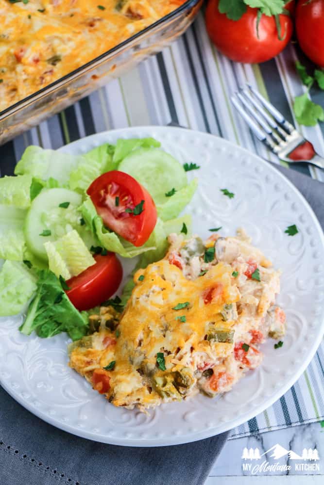 king ranch chicken on white plate with salad