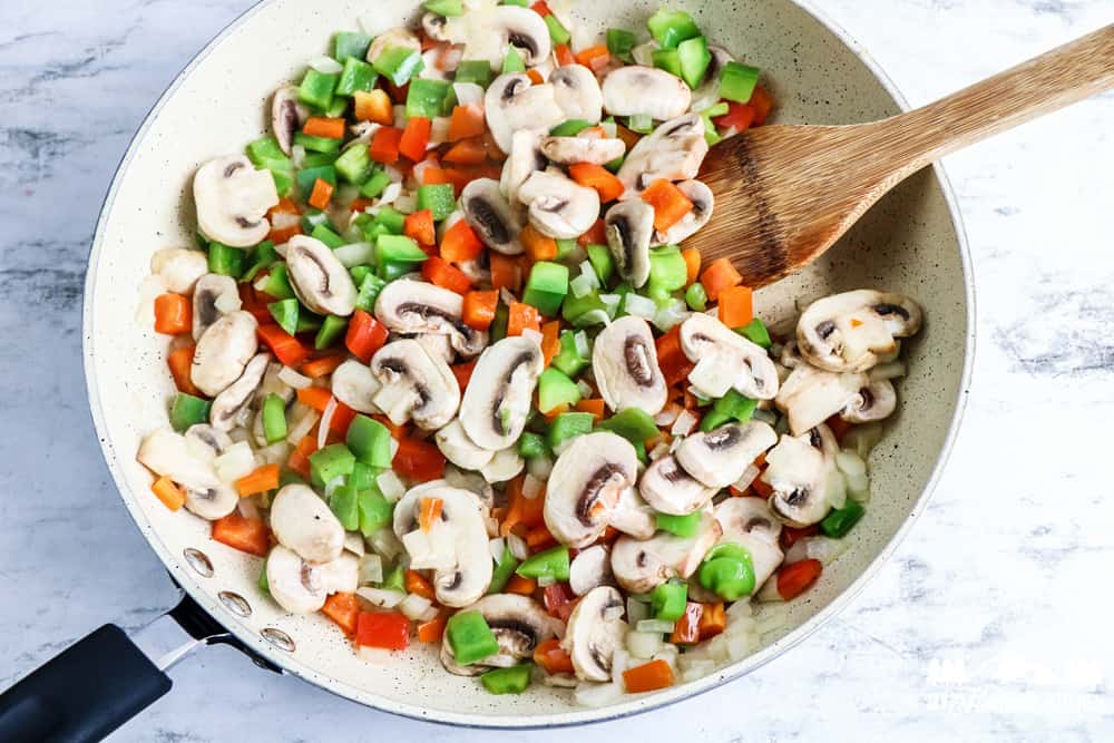 peppers and mushroom in a frying pan