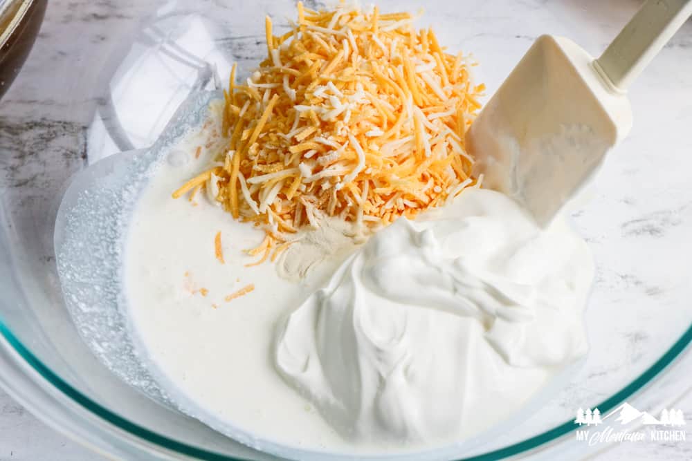 sour cream and shredded cheese in a glass bowl