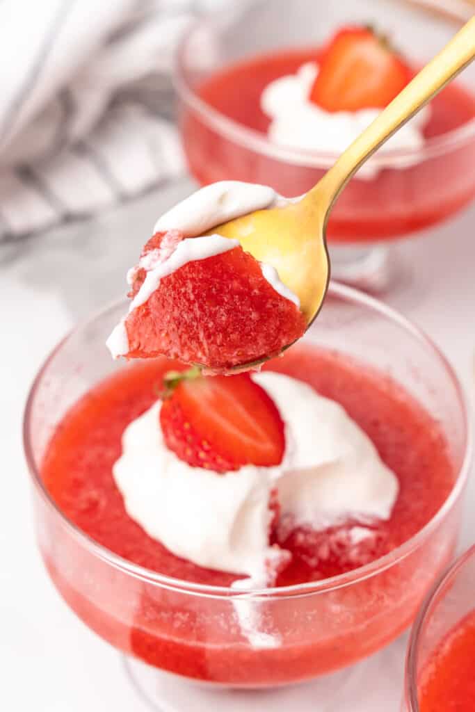 strawberry gelatin dessert on golden spoon
