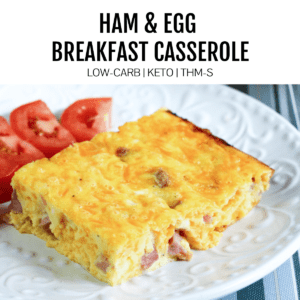 breakfast casserole on white place with tomatoes