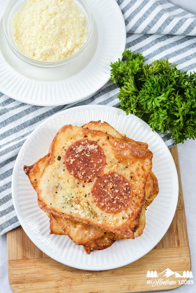 crispy keto pizza crackers on white plate