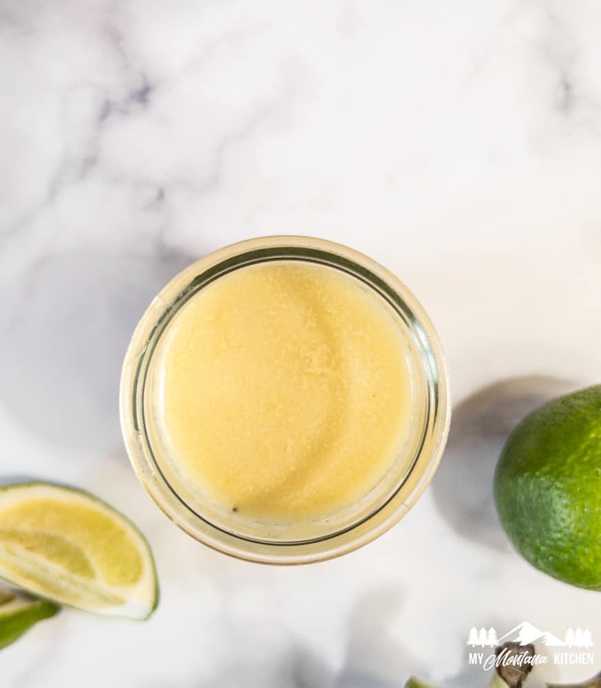 lime vinaigrette in glass jar with limes