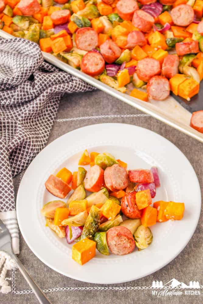 roasted vegetables and sausage on white plate