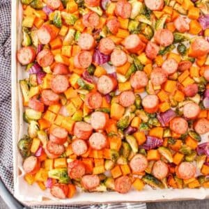 roasted vegetables and sausage on aluminum sheet pan