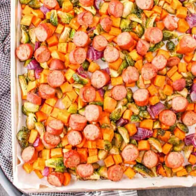 roasted vegetables and sausage on aluminum sheet pan